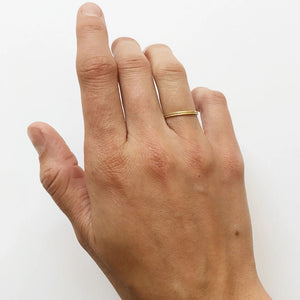 Hand modeling two delicate gold stacking rings by Truss and Ore