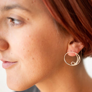 Woman modeling sterling silver Carrie earrings by Truss and Ore