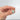 Hand holding gold gondola charm