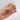 Hand holding gold tennis racket charm