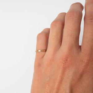 Hand modeling vintage 14k gold ring band with a decorative, engraving like motif around the band
