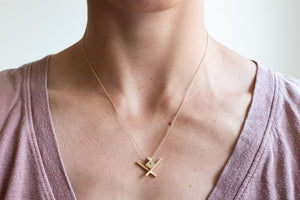 Woman modeling handmade, symmetric 18k gold Lietuva necklace by Truss and Ore