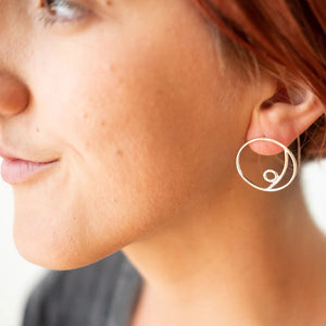 Woman modeling handmade, sterling silver Mae earrings by Truss and Ore